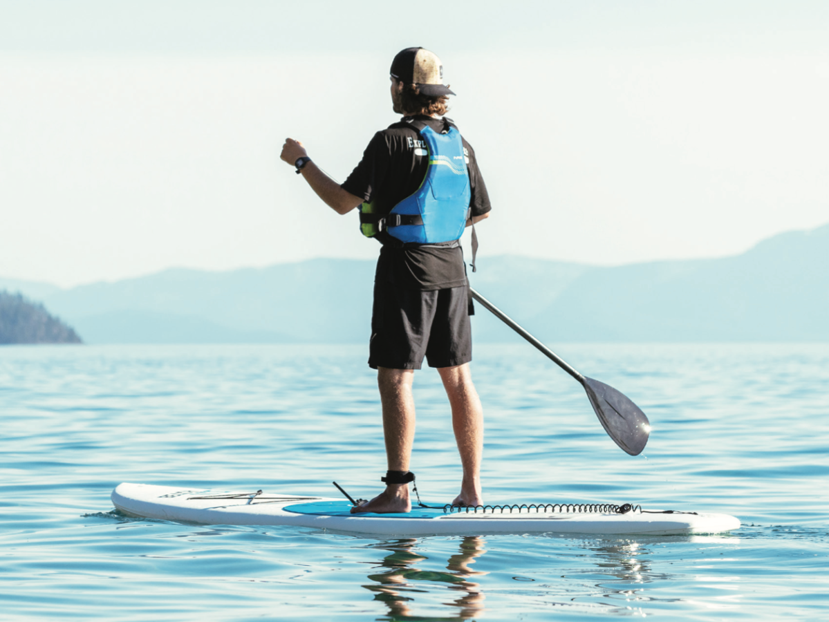 a person standing next to a body of water